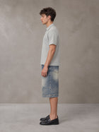 Model wearing SM Sig. Half-Zip Polo Shirt in Floral Grey, side view.