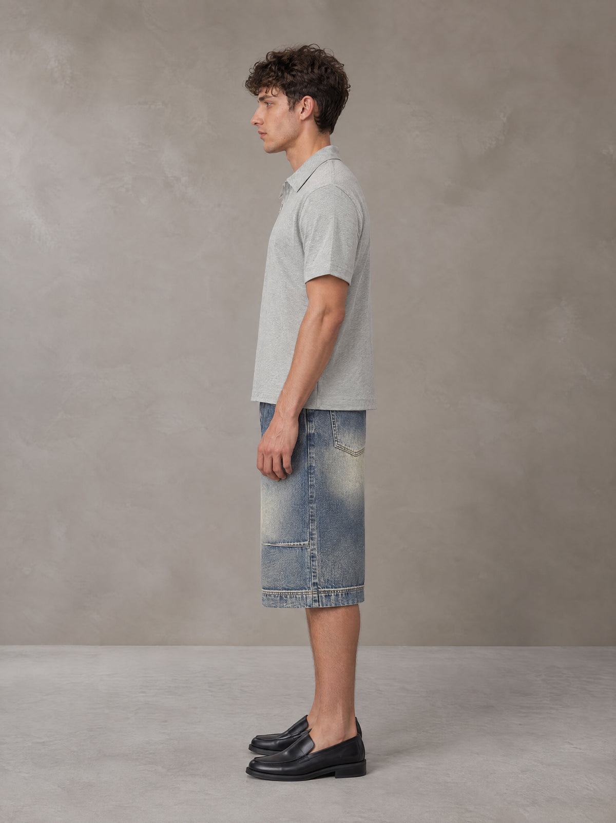 Model wearing SM Sig. Half-Zip Polo Shirt in Floral Grey, side view.