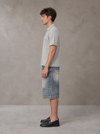 Model wearing SM Sig. Half-Zip Polo Shirt in Floral Grey, side view.
