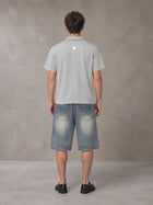 Model wearing SM Sig. Half-Zip Polo Shirt in Floral Grey, rear view.