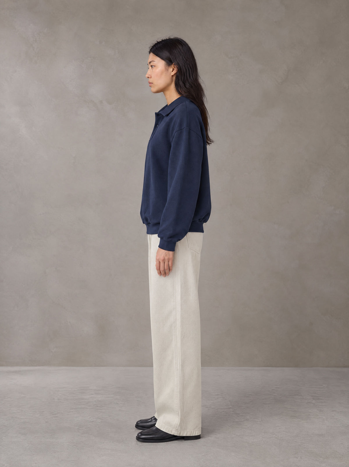 Model wearing SM Sig. Fleece Polo Sweatshirt in Oxford Navy, side view.