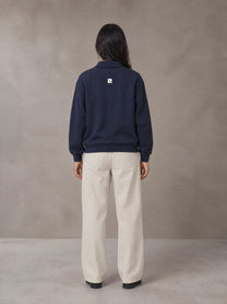 Model wearing SM Sig. Fleece Polo Sweatshirt in Oxford Navy, rear view.