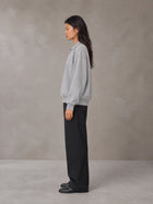 Model wearing SM Sig. Fleece Polo Sweatshirt in Floral Grey, side view.
