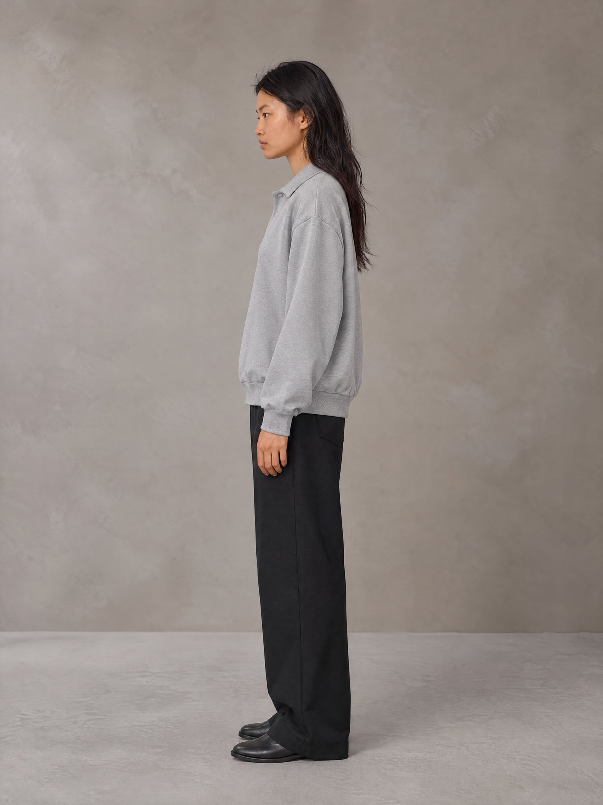 Model wearing SM Sig. Fleece Polo Sweatshirt in Floral Grey, side view.