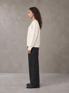 Model wearing SM Straight Leg Trousers in Midnight Black, side view.