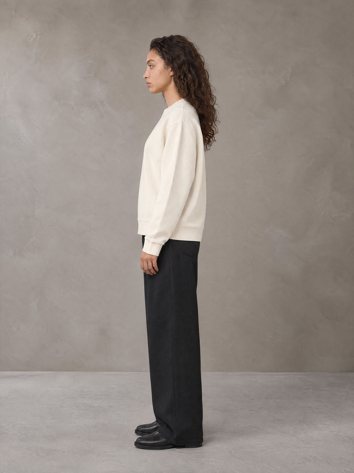 Model wearing SM Straight Leg Trousers in Midnight Black, side view.
