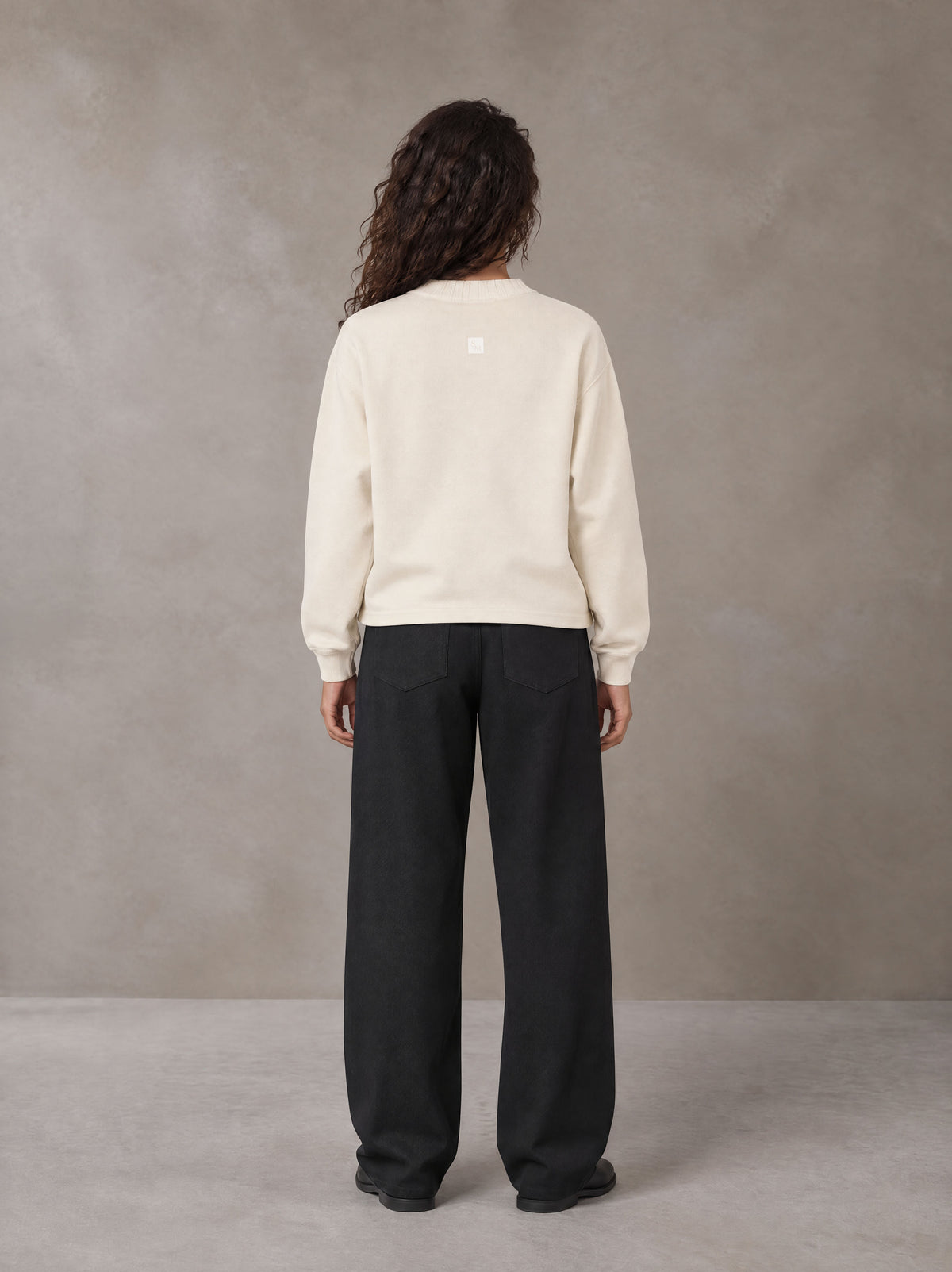Model wearing SM Straight Leg Trousers in Midnight Black, rear view.