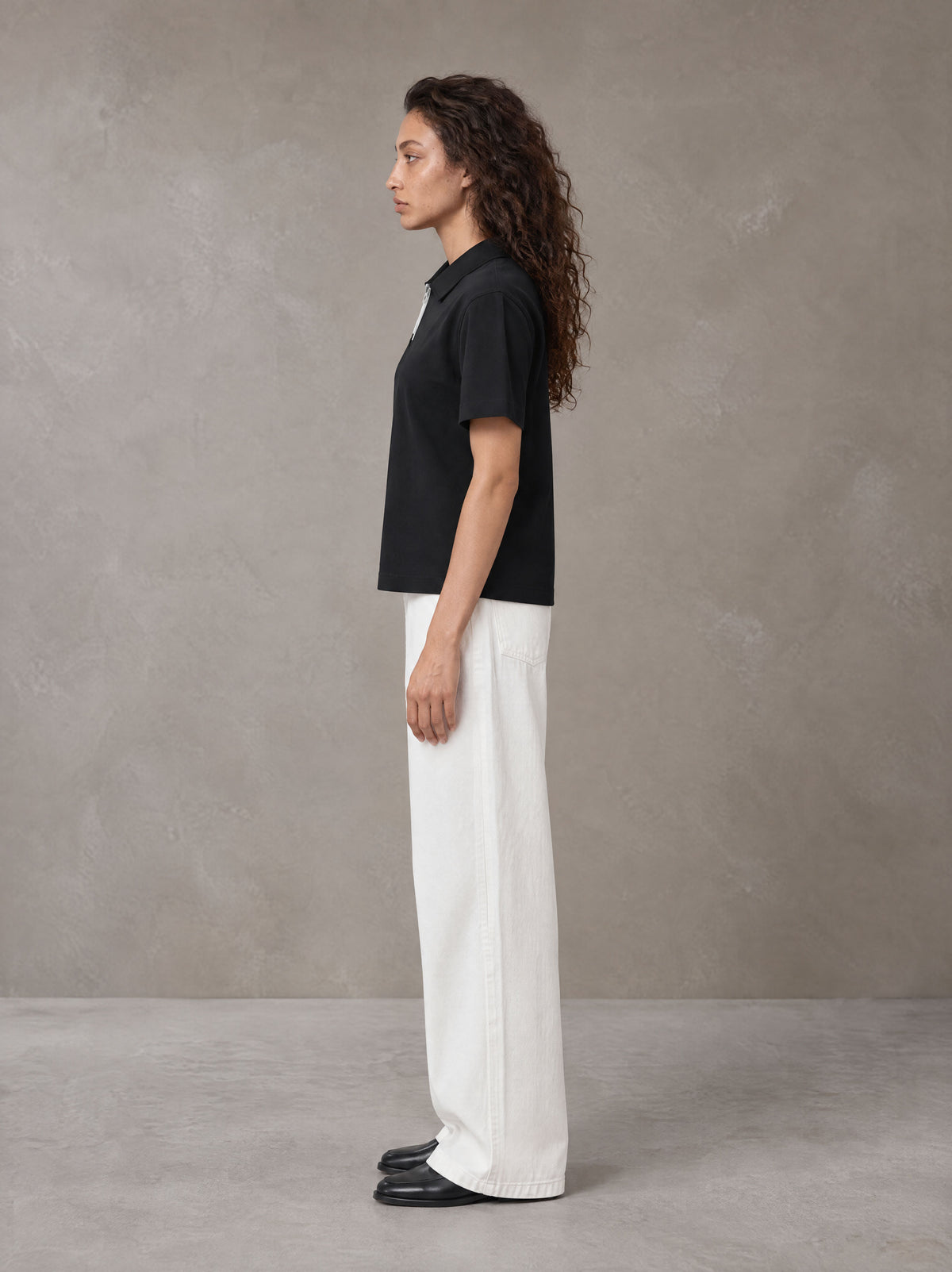 Model wearing SM Straight Leg Trousers in Lucent White, side view.