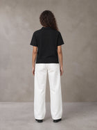 Model wearing SM Straight Leg Trousers in Lucent White, rear view.
