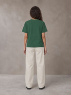 Model wearing SM Straight Leg Trousers in Oat Grey, rear view.