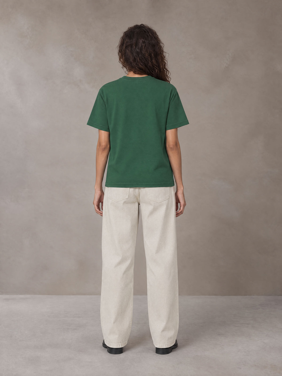 Model wearing SM Straight Leg Trousers in Oat Grey, rear view.