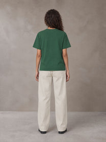 Model wearing SM Straight Leg Trousers in Oat Grey, rear view.