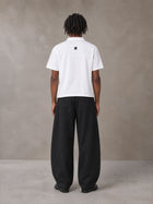 Model wearing SM Curved Trousers in Midnight Black, rear view.