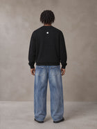 Model wearing SM Sig. Knitted Round Neck Sweatshirt in Midnight Black, rear view.