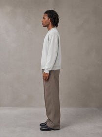Model wearing SM Sig. Knitted Round Neck Sweatshirt in Solitude, side view.