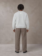 Model wearing SM Sig. Knitted Round Neck Sweatshirt in Solitude, rear view.
