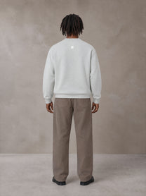 Model wearing SM Sig. Knitted Round Neck Sweatshirt in Solitude, rear view.