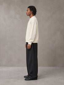 Model wearing SM Sig. Knitted Round Neck Sweatshirt in Neutral Heather, side view.