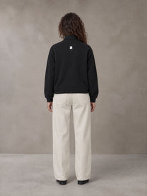 Model wearing SM Sig. Half-Zip Fleece Sweatshirt in Midnight Black, rear view.