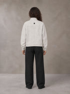 Model wearing SM Sig. Half-Zip Fleece Sweatshirt in Oat Grey, rear view.