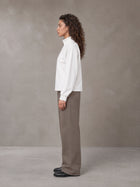 Model wearing SM Sig. Half-Zip Fleece Sweatshirt in Lucent White, side view.