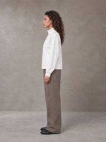 Model wearing SM Sig. Half-Zip Fleece Sweatshirt in Lucent White, side view.