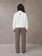 Model wearing SM Sig. Half-Zip Fleece Sweatshirt in Lucent White, rear view.
