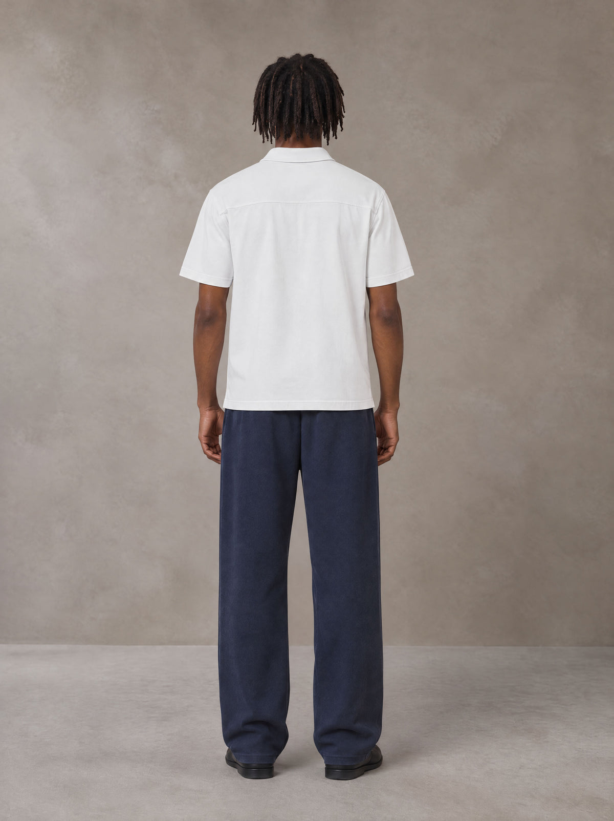 Model wearing SM Sig. Sun Fade Sweatpants in Oxford Navy, rear view.