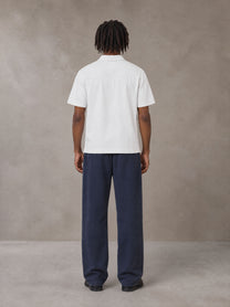 Model wearing SM Sig. Sun Fade Sweatpants in Oxford Navy, rear view.