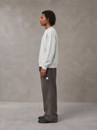 Model wearing SM Sig. Sun Fade Sweatpants in Kabul Brown, side view.
