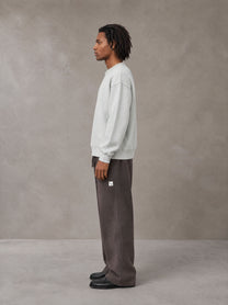 Model wearing SM Sig. Sun Fade Sweatpants in Kabul Brown, side view.