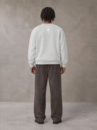 Model wearing SM Sig. Sun Fade Sweatpants in Kabul Brown, rear view.
