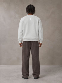 Model wearing SM Sig. Sun Fade Sweatpants in Kabul Brown, rear view.