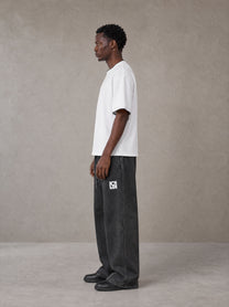 Model wearing SM Snow Fade Sweatpants in Midnight Black, side view.