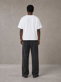 Model wearing SM Snow Fade Sweatpants in Midnight Black, rear view.