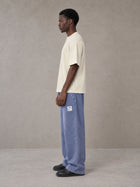 Model wearing SM Snow Fade Sweatpants in Chambray, side view.