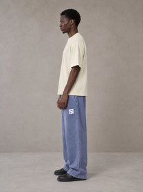 Model wearing SM Snow Fade Sweatpants in Chambray, side view.