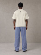 Model wearing SM Snow Fade Sweatpants in Chambray, rear view.