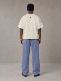 Model wearing SM Snow Fade Sweatpants in Chambray, rear view.