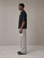 Model wearing SM Snow Fade Sweatpants in Floral Grey, side view.