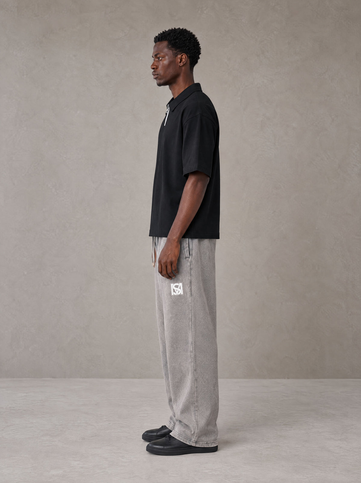 Model wearing SM Snow Fade Sweatpants in Floral Grey, side view.