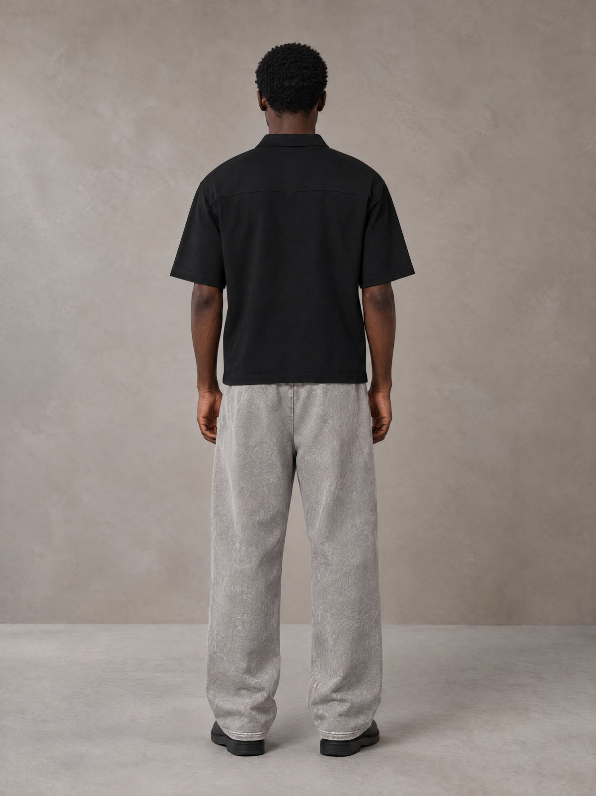 Model wearing SM Snow Fade Sweatpants in Floral Grey, rear view.