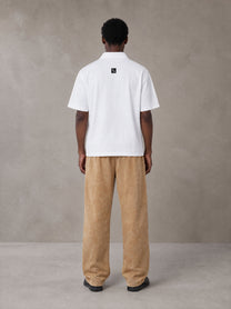 Model wearing SM Snow Fade Sweatpants in Aged Whiskey, rear view.