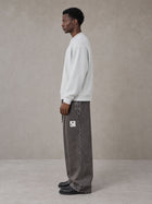 Model wearing SM Snow Fade Sweatpants in Graphite, side view.