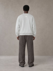 Model wearing SM Snow Fade Sweatpants in Graphite, rear view.