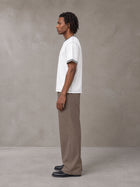 Model wearing SM Sig. Contrast Stitch T-shirt in Lucent White, side view.
