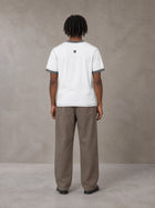 Model wearing SM Sig. Contrast Stitch T-shirt in Lucent White, rear view.