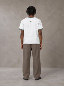 Model wearing SM Sig. Contrast Stitch T-shirt in Lucent White, rear view.