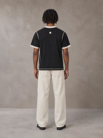 Model wearing SM Sig. Contrast Stitch T-shirt in Midnight Black, rear view.