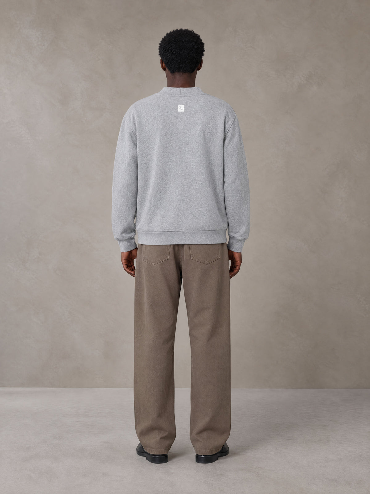 Model wearing SM Sig. Cardigan in Floral Grey, rear view.
